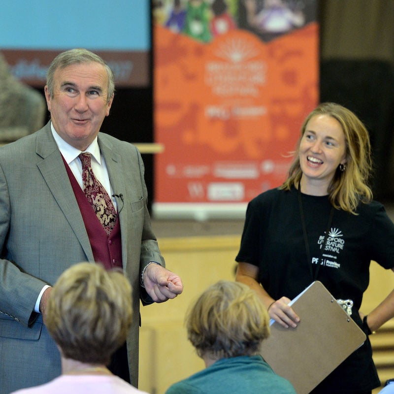 Gervase Phinn and staff smiling at festival event