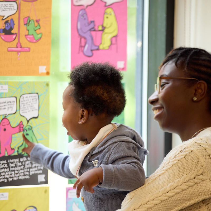 A parent and child view an exhibition at BLF 2025