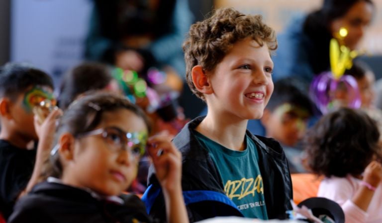 A child smiles at a storytelling session at BLF 2025