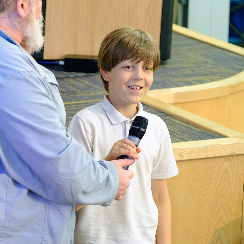 A Primary school student speaks into a microphone at a BLF 2025 Education Programme event