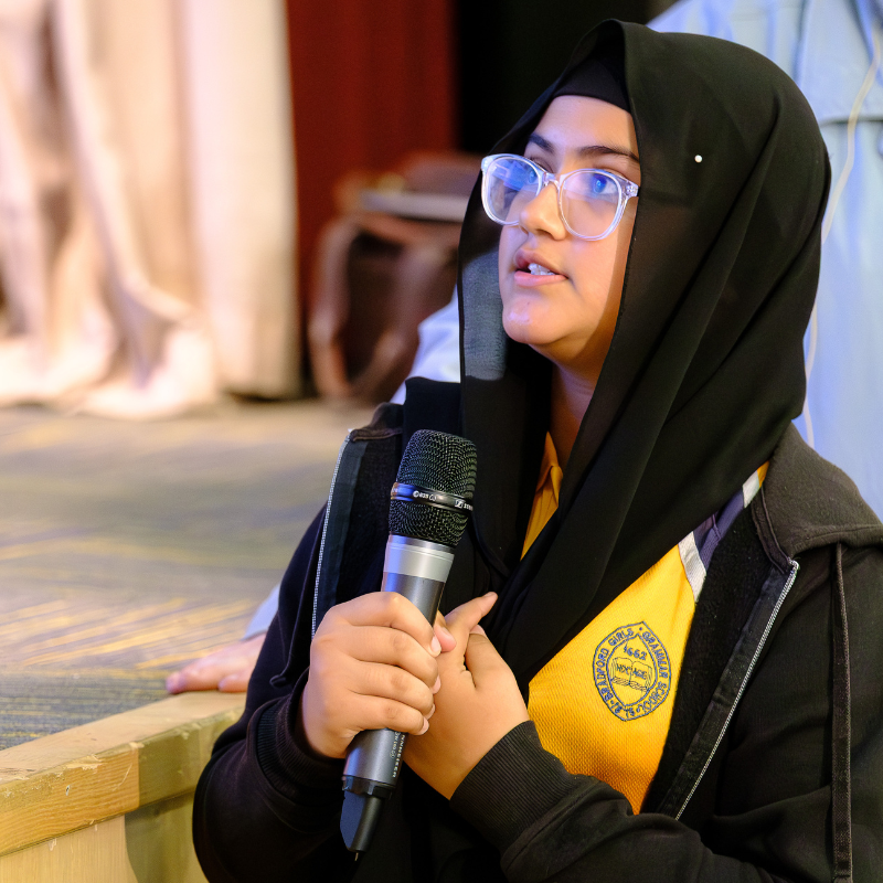 A Primary school student speaks into a microphone at a BLF 2025 Education Programme event